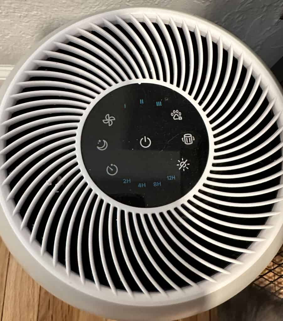 An image of the Levoit plug-in air purifier, top down view with variety of settings, speeds, and sleep option.