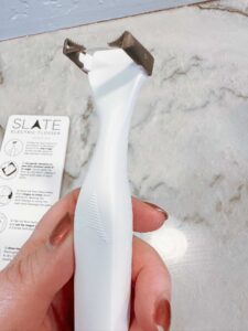 A close up photo of the Slate electric flosser